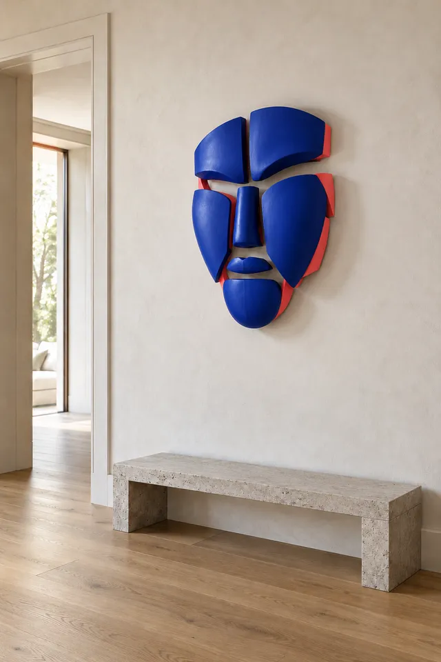 Concept render. Seven separate ultramarine forms suggest a calm face, with coral returns above a low stone bench.